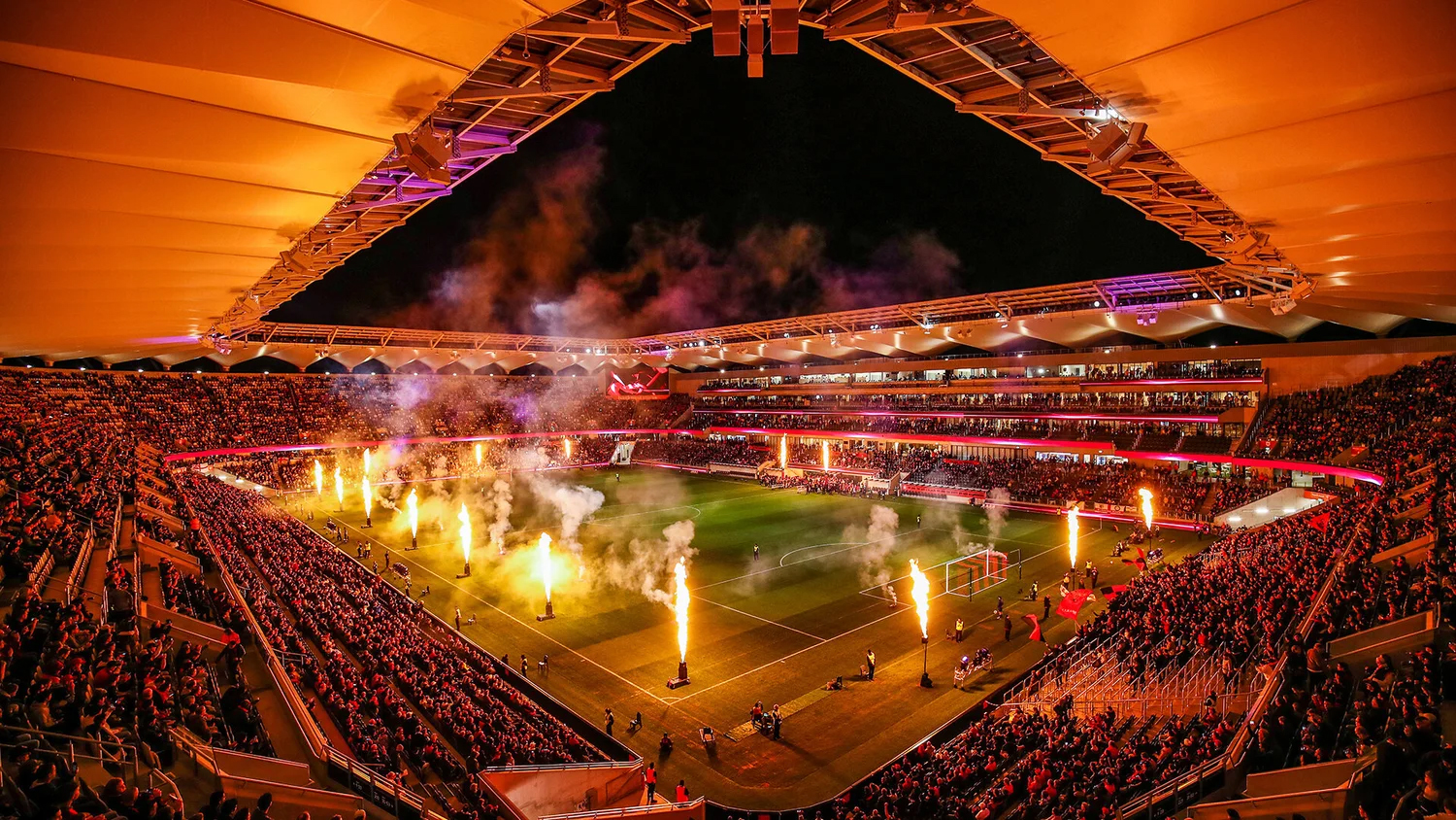 Stadium sports event with pyrotechnics and crowd